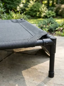 Weather-resistant mesh, reinforced seams, and raised frame on an outdoor dog bed